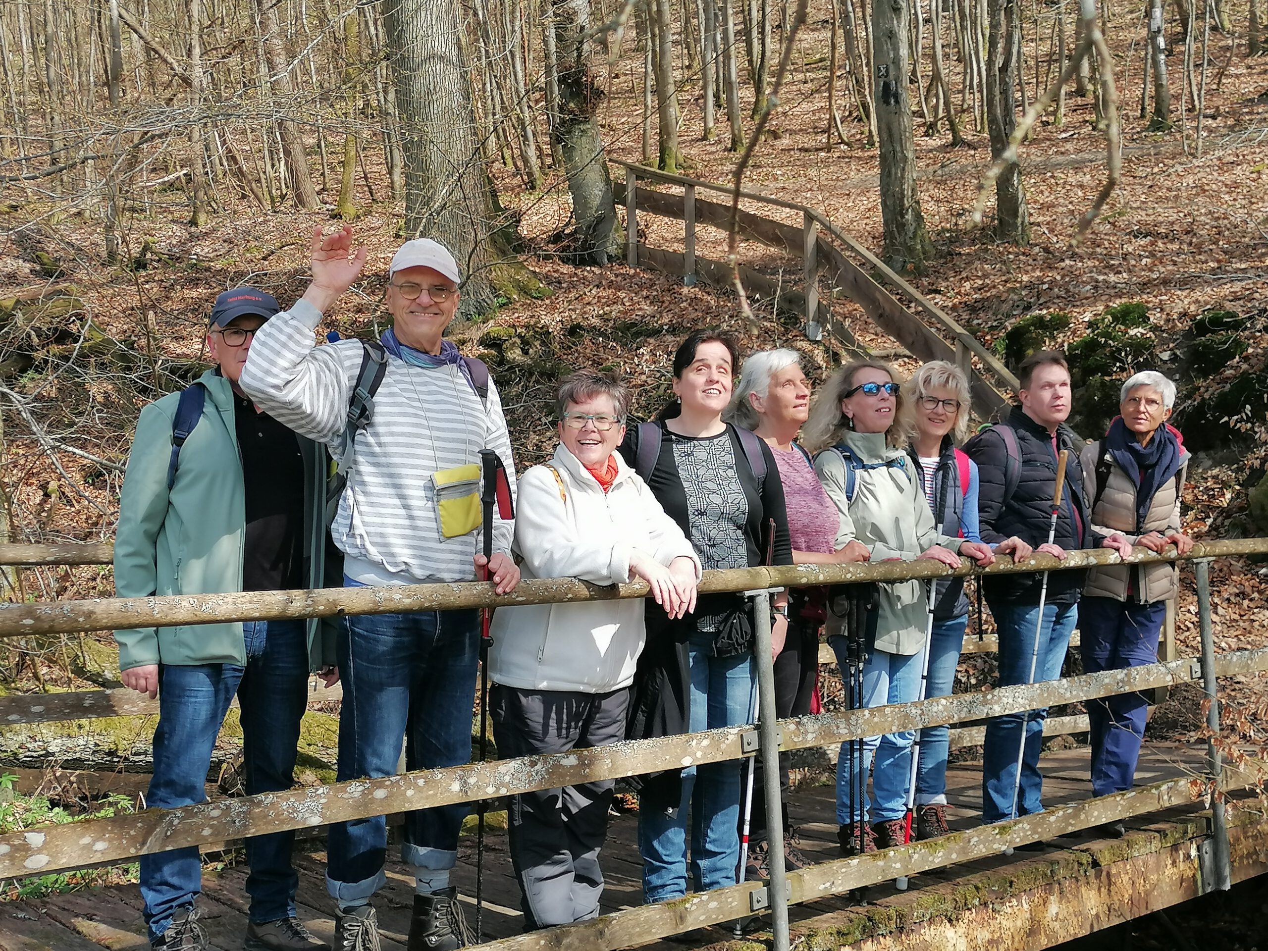 Die Wandergruppe auf einer Brücke stehend, mit Wald im Hintergrund.<br />
